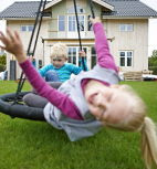 Children swinging in the garden