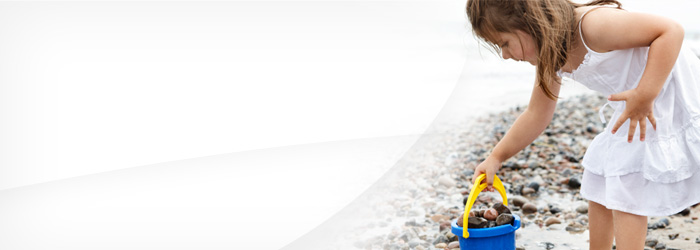 Child collecting rocks on the beach